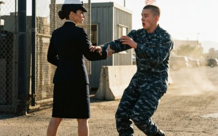 "Step back, ma'am," the young recruit said, his hand already reaching for her arm at the base gate. He had just graduated boot camp weeks ago — chest puffed, ego blazing, ready to prove himself to anyone who crossed his path. But when she didn't flinch, when her eyes stayed calm and steady, something in his gut told him to stop. He didn't listen. Then her grip locked around his wrist with surgical precision, he hit the ground in under three seconds, and the senior guard rushed over with a look that said everything. That woman wasn't just anyone. She was Lieutenant Commander Raina Hail — Navy SEAL combat master — and she had just decided to teach him the most brutal lesson of his life.