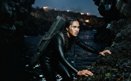 "We're finished," the SEAL commander said into the radio as his team bled out in a concrete bunker on a forgotten Pacific island. They were surrounded by 40 trained mercenaries with no rescue coming for hours. Then a single figure rose from the water 300 meters away — a 17-year-old girl with her father's sniper rifle — and the enemy had no idea the hunter had just arrived.