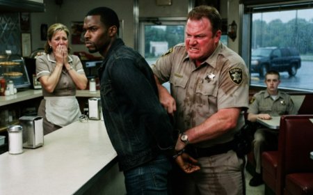 "Turn around and put your hands behind your back," the sheriff ordered, his handcuffs already clicking open. The man didn't resist — just stood there, calm and silent, as the metal bit into his wrists. Then the sheriff flipped open his wallet, saw two silver stars, and went pale. Before he could speak, state police surrounded the diner — and the governor walked straight through the door.